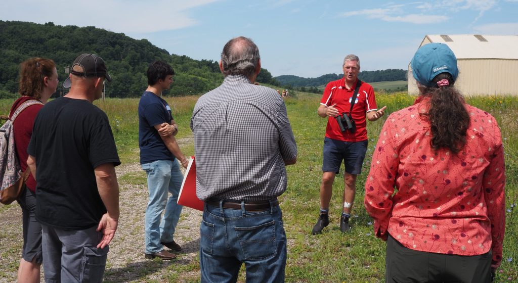 A group of people outside on a sunny day
