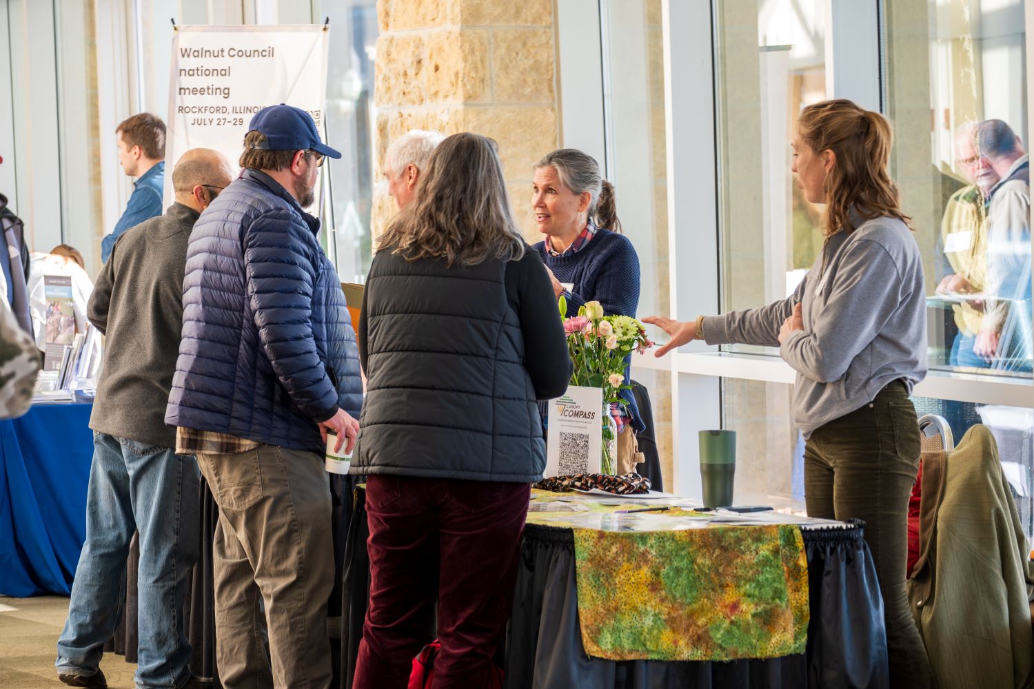 landowners talking with natural resource professionals at a conference booth